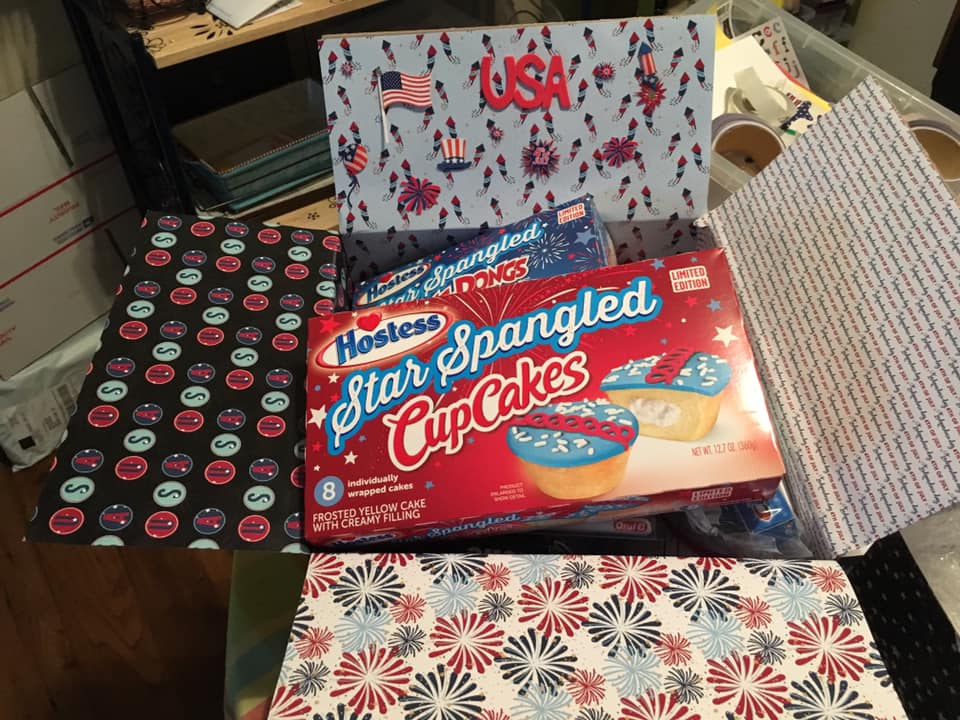 Decorated box standing on a table and overflowing with treats