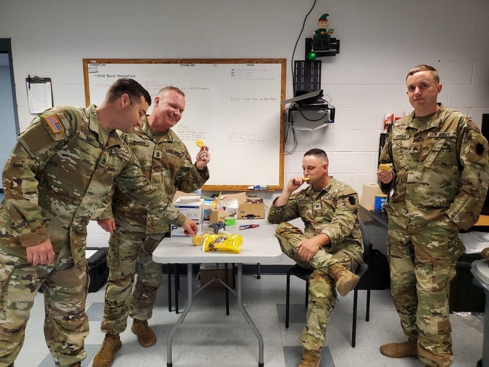service members eating Girl Scout cookies