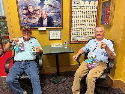 Veterans holding boxes of Girl Scout cookies