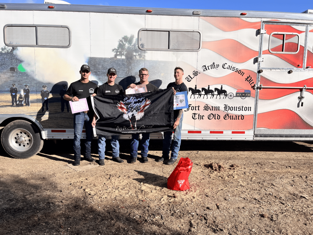 Pat delivering Valentine's Day cards to Caisson unit, holding a flag
