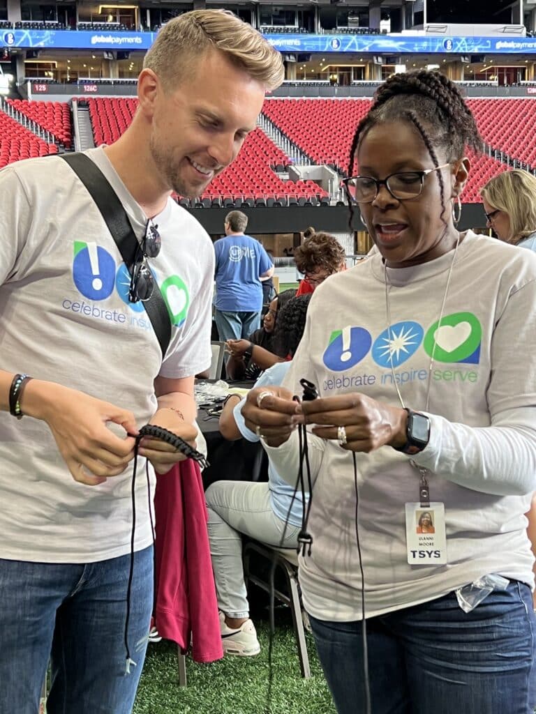 corporate engagement activity making paracord bracelets for care packages