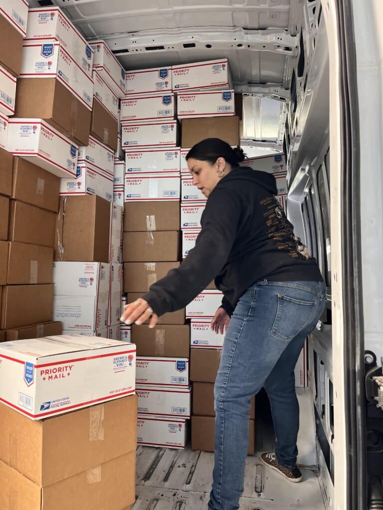 Loading a van with Carepackages filled with Girl Scout Cookies