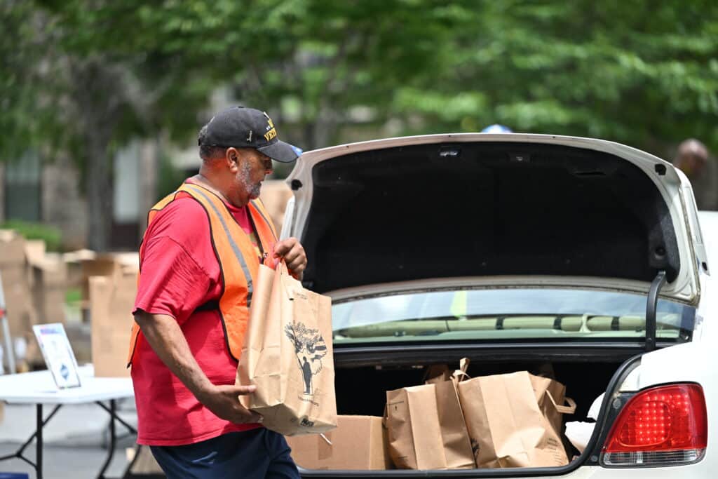 A volunteer loading food into a vehicle at a Soldiers' Angels drive-through distribution